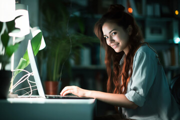 Beautiful young woman working on a computer in an office