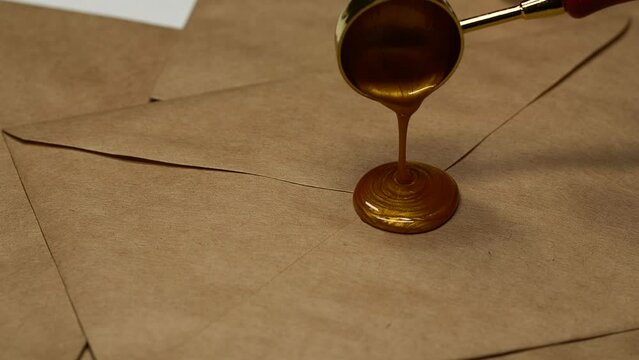 Golden vintage wax stamp with floral ornament sealing on craft postal envelope