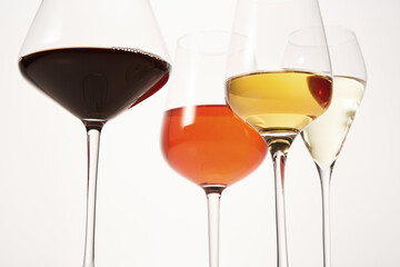 Pink, white, red, sparkling alcoholic drinks in wine glasses.