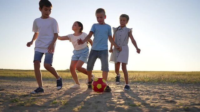 Football match in park at sunset.family in park with soccer ball, having fun.Fun for whole family playing in park at sunset.Family game in park fun with soccer ball on green grass.Happy family concept