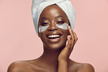 African American Woman Using Collagen Eye Patches On Pink Isolated, Beauty Portrait