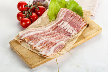 Sliced pork bacon oved board