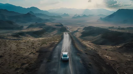 Fotobehang a sleek, modern car as it winds its way through the expansive and rugged terrain of a high mountain landscape © Christian