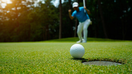 Golfer action to win after long putting golf ball in to the hole. - obrazy, fototapety, plakaty