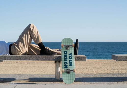 Mockup of man lying down with customizable skateboard