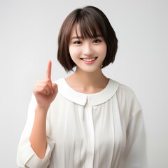 10代の人差し指でおすすめする微笑む美しい女性