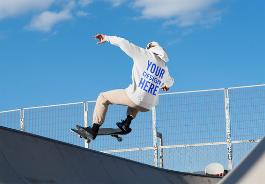 Mockup of skateboarder wearing customizable hoodie, low angle