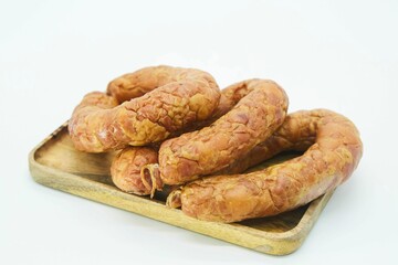 Meat dish sausage on a wooden board. The product is ready to use. White background.