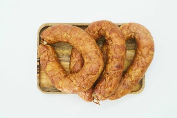Meat dish sausage on a wooden board. The product is ready to use. White background.
