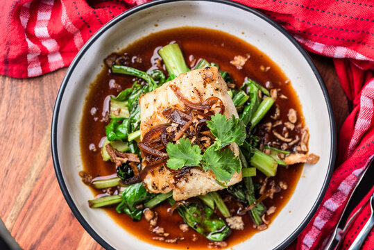 A serve of Grilled Rockling, served with asian greens and soy sauce.