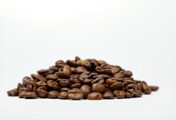 pile of coffee beans isolated on white background and copy space