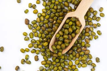 Mung beans isolated on white with wooden scoop and copy space