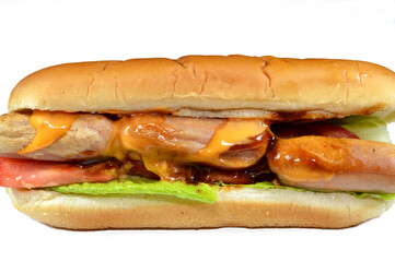 chicken hot dog with thousand island dressing sauce of ketchup mayonnaise, grilled chicken sausage, tomato, lettuce, called wiener (Vienna sausage), frankfurter frank, in a partially sliced hotdog bun