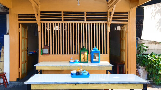 Empty seat bamboo and wooden humble asian traditional restaurant food stall in the morning. Good place for dine-In breakfast or lunch. Street food warung sell soto ayam or soto daging.