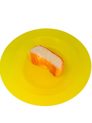 a piece of bread on a yellow plastic plate, isolated on white background, concept of hunger, poverty and inflation that impact society or humans.