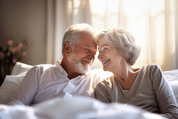 An elderly man and woman laying side by side on a bed, showcasing love and companionship in their relationship