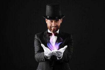 Magic and sorcery. Magician with fantastic light on dark background