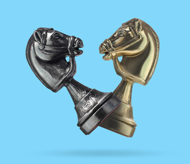 Chess knights in air on light blue background © New Africa