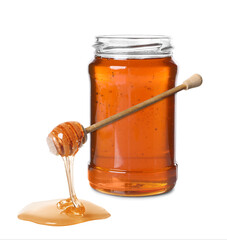 Natural honey dripping from dipper. Jar full of honey on white background