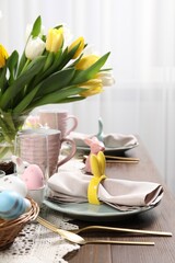 Festive table setting with beautiful flowers. Easter celebration