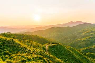 Obraz premium summer scenery mountain view from a highland hill to a beautiful sunset.