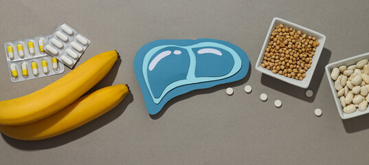 Paper mockup of liver, pills and food on gray background, top view