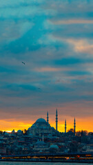 Suleymaniye Mosque with dramatic clouds at sunset.