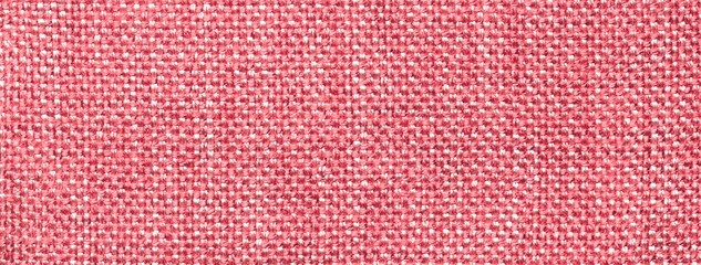 Texture of light red color background from woven textile material with wicker pattern, macro.