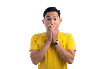 Portrait of handsome Asian man covering his mouth showing shocked expression isolated on white background