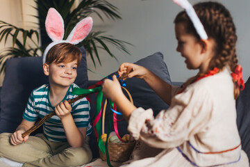 Boy holding handmade whip, made of willow branches, decorated with ribbons. Unique easter custom from slovakia, gently whipping woman and tranditional verses and easter wishes.