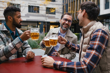 Best friends togehter, drinking beer and talking in bar in city. Concept of male friendship, bromance.