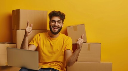 Photo of reliable promoter guy sit desktop raise thumb up netbook pile carton box wear yellow shirt home indoors - obrazy, fototapety, plakaty