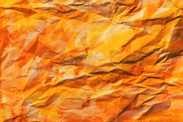 Texture of crumpled paper painted with yellow and orange aquarelle water color paint