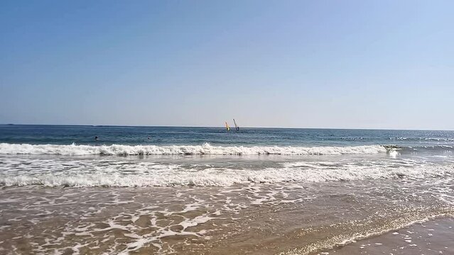Seascape. People relaxing and swiming in sea on hot summer day. Active recreation, windsurfing in Bulgaria on Black Sea coast. Perla beach in Primorsko.