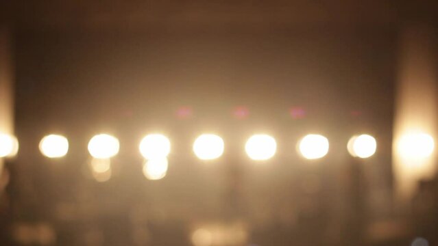 Show or performance beginning. Concert stage with bright light soffits. Blurred background for introduction video