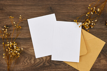 Blank greeting cards, flyer or invitation card mockup with gypsophila flowers, brown craft envelope...