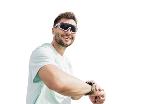 A man in sports glasses uses a fitness watch on his arm smiling warm-up workout in fitness clothes. Transparent isolated background.