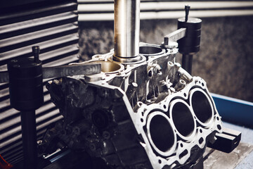Three-cylinder engine repair on CNC machine, boring under the piston using machine with Computer Numerical Control. 