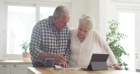Senior couple, documents and stress on tablet with financial paperwork, taxes or retirement questions at home. Planning, debt and elderly people in kitchen with insurance, bills or asset management