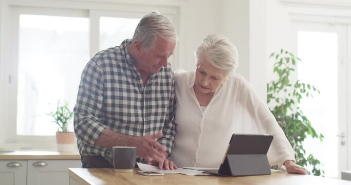 Senior couple, documents and stress on tablet with financial paperwork, taxes or retirement questions at home. Planning, debt and elderly people in kitchen with insurance, bills or asset management