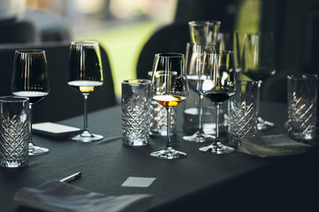 Layout of wine glasses on the table, preparing for the tasting of alcoholic beverages. Preparation...