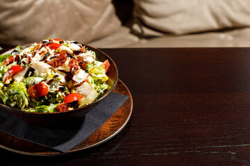 Mixed healthy salat served in wooden plate on background