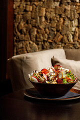 Mixed healthy salat served in wooden plate on background