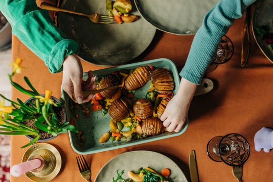 Family having freshly baked potatoes at Easter dinner
