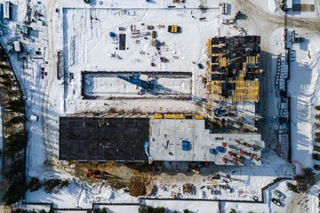 the construction site of an apartment building in the winter from a height