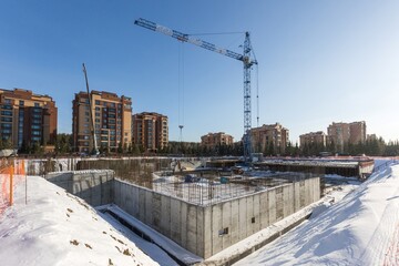 the construction site of an apartment building in the winter from a height
