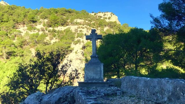 Christian Stone Cross. Stone cross positioned on a mountain side. Monastery. Religion. Brac Island, Croatia. Europe.