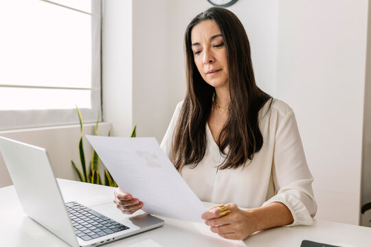 HR manager reading candidate's resume in office