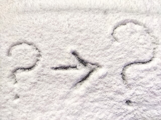 Two question marks and arrow written in the snow. The cold frosty texture of the snow and the question mark. Background, place for text, copy space