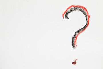 Hand-drawn question mark, boldly marked in black on a white sheet of paper, symbolizing the concept of questioning, uncertainty, and the search for information